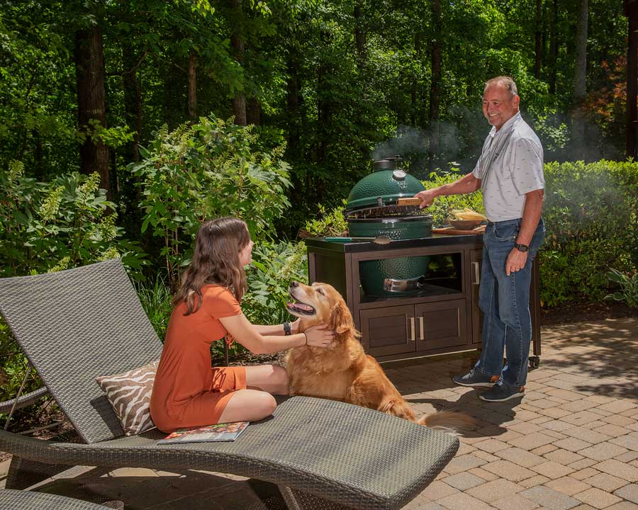 Big Green Egg outside grill with golden retriever