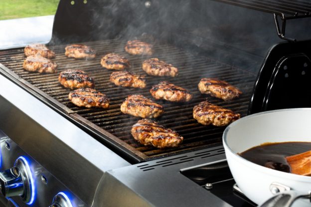 Open grill with pork burgers